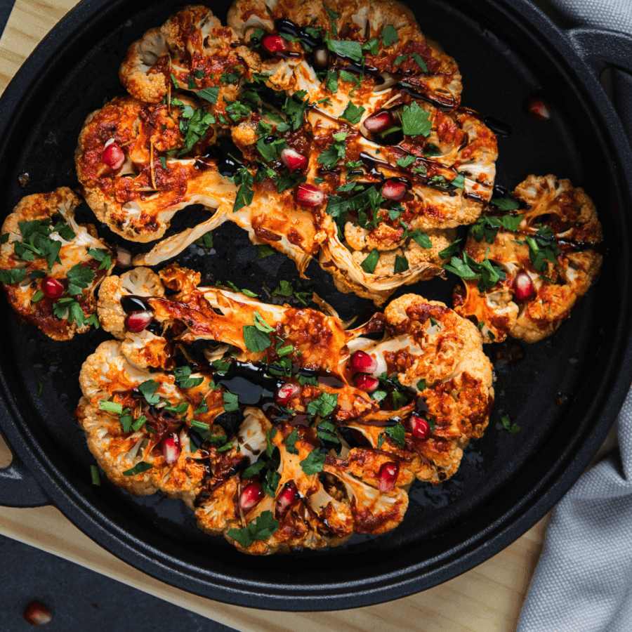 cauliflower steak being drizzled with balsamic glaze