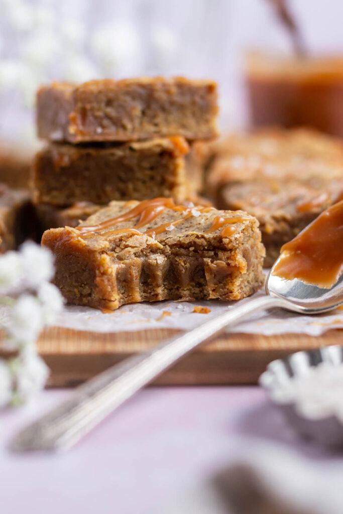 A close-up image of a spoonful of salted caramel brownie oatmeal being lifted from the baking dish.