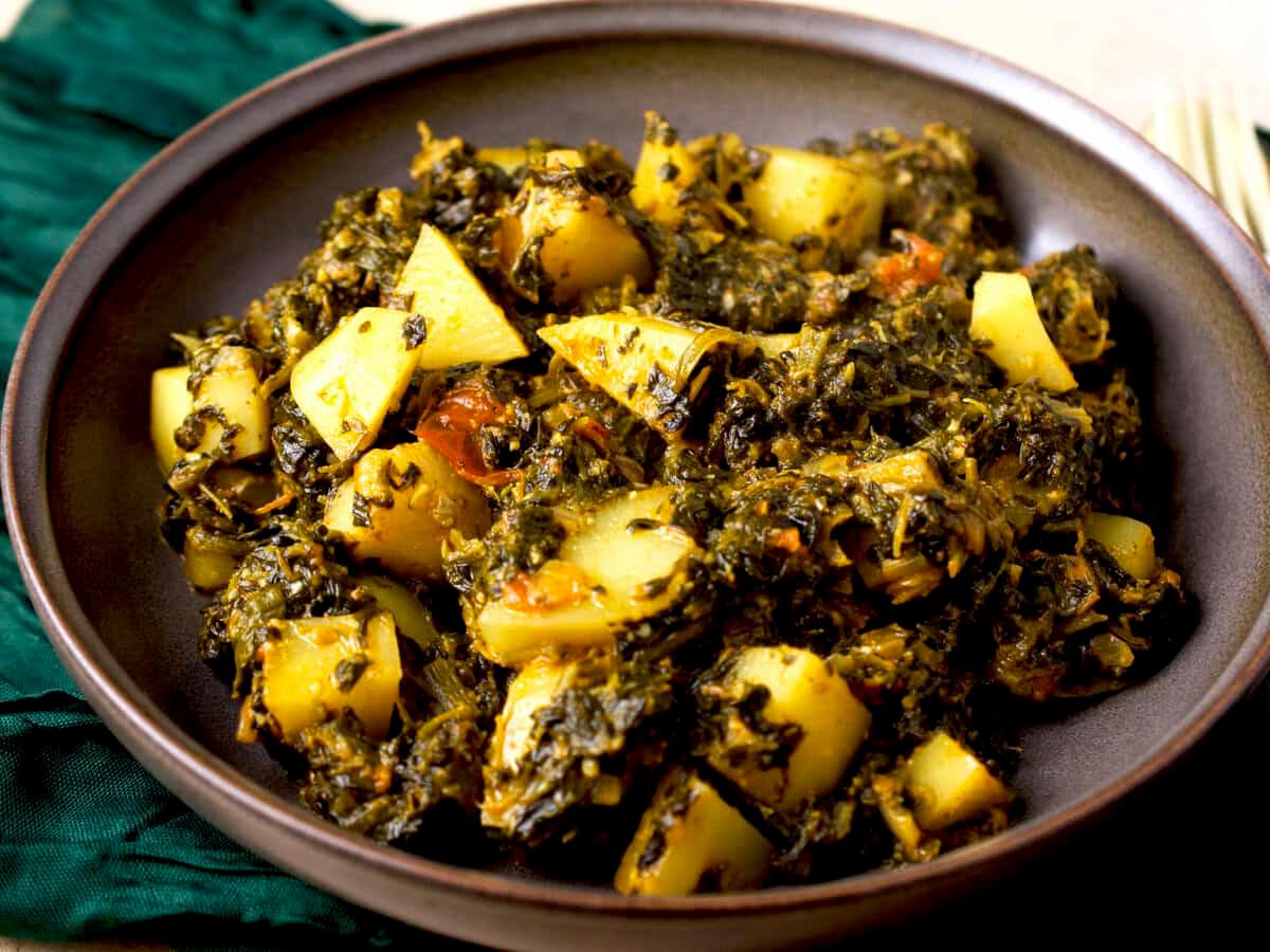 Close-up shot of Aloo Palak Pizza showing the texture and vibrant colors