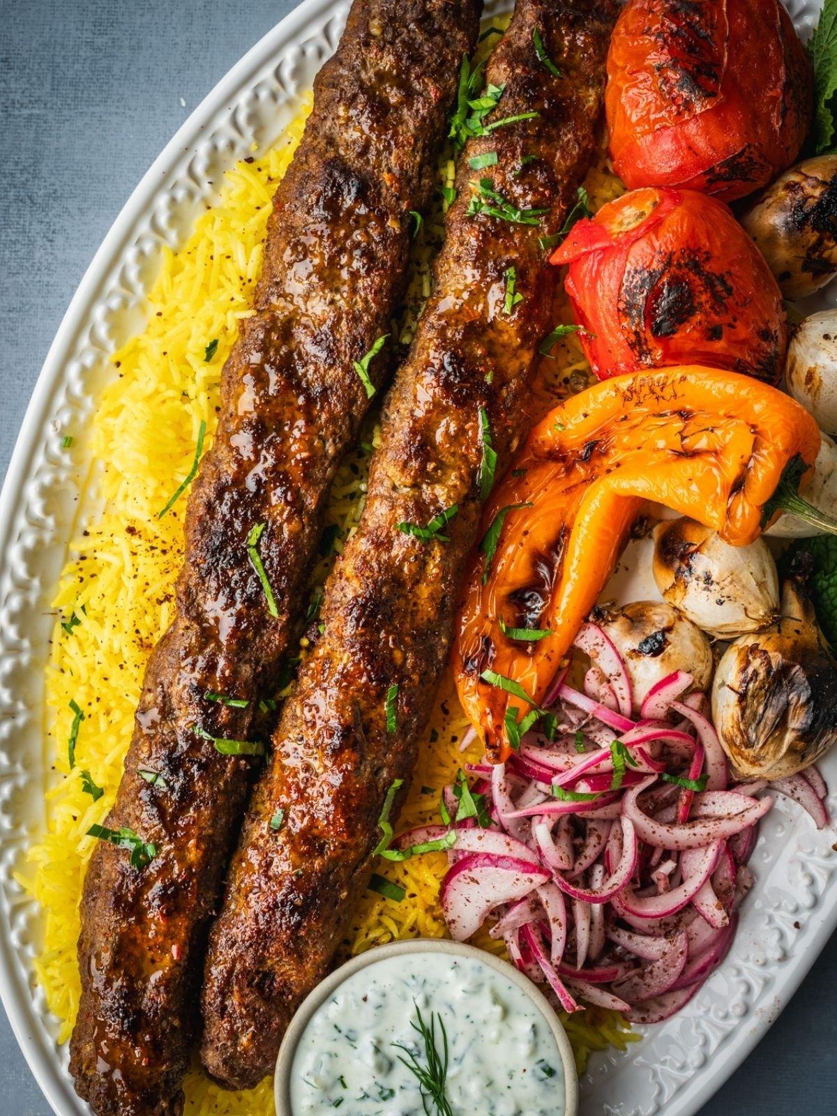 Beef kebabs served on a platter with side dishes