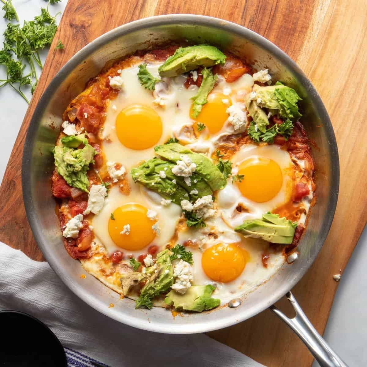 Skillet with Jollof Shakshuka, eggs with runny yolks