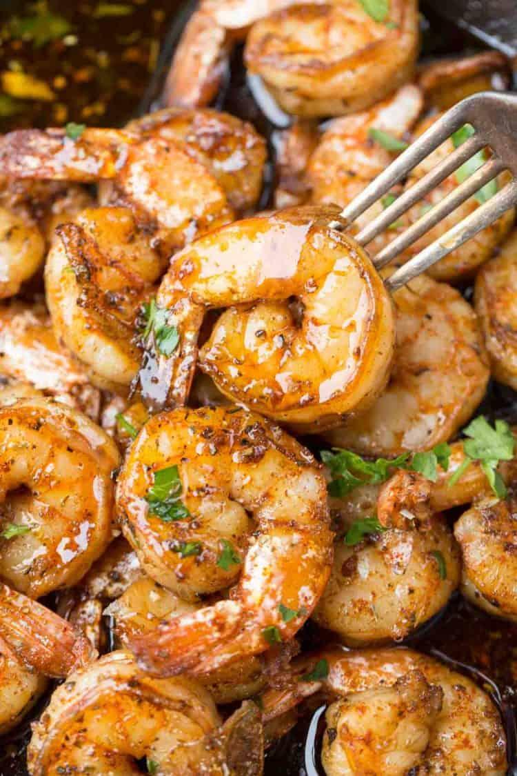 A close up of shrimp being sautéed in garlic butter