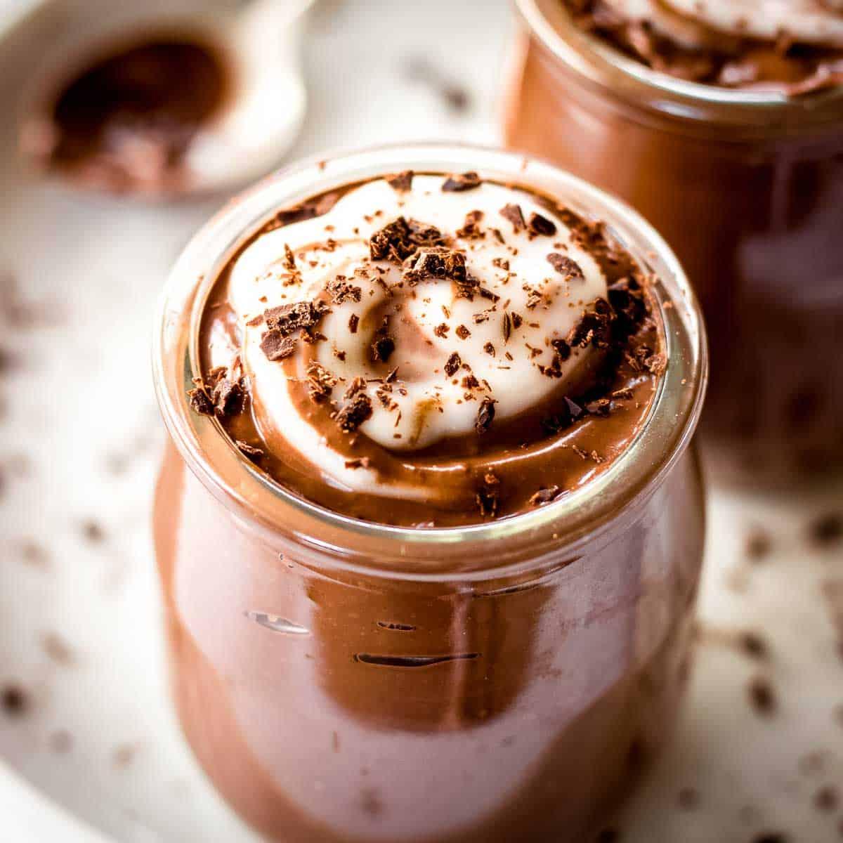Close-up shot of creamy avocado chocolate mousse with sea salt sprinkled on top in elegant glasses