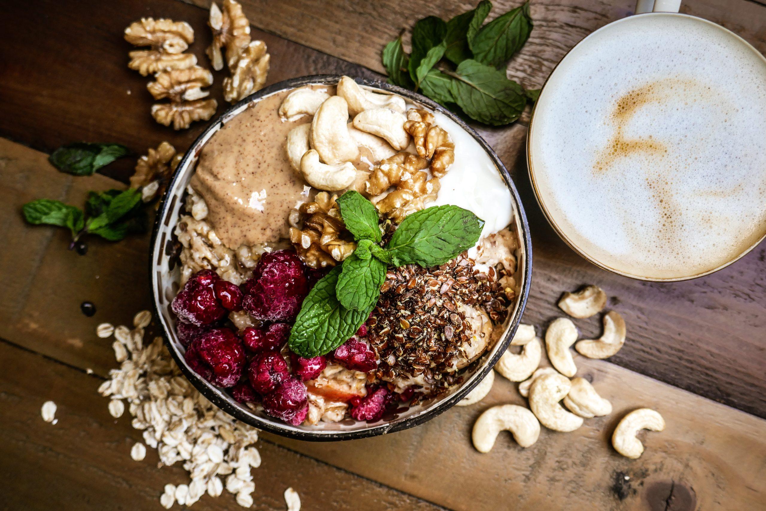 A bowl of creamy coconut oatmeal with toppings such as berries and nuts