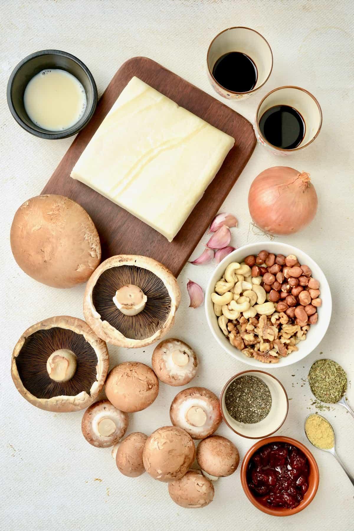 Ingredients for Vegan Boursin and Mushroom Wellington laid out on a wooden surface