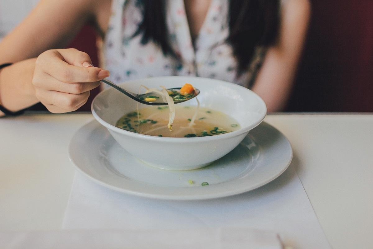 person eating a bowl of vegan soup