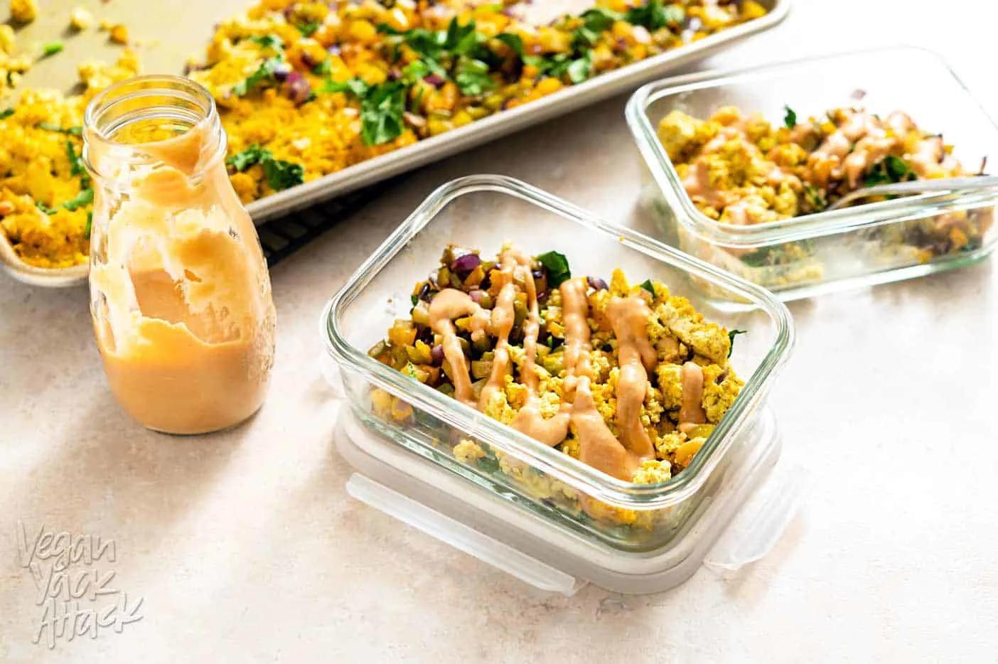 Several containers of tofu scramble meal prepped in the fridge
