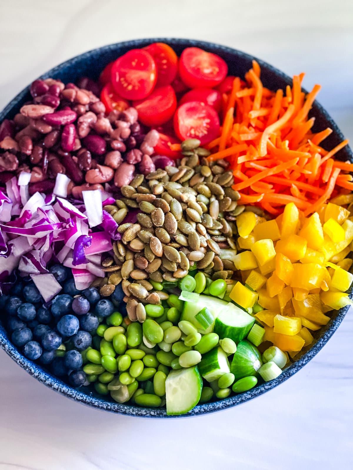 Close-up shot of a vibrant rainbow veggie salad in a large bowl