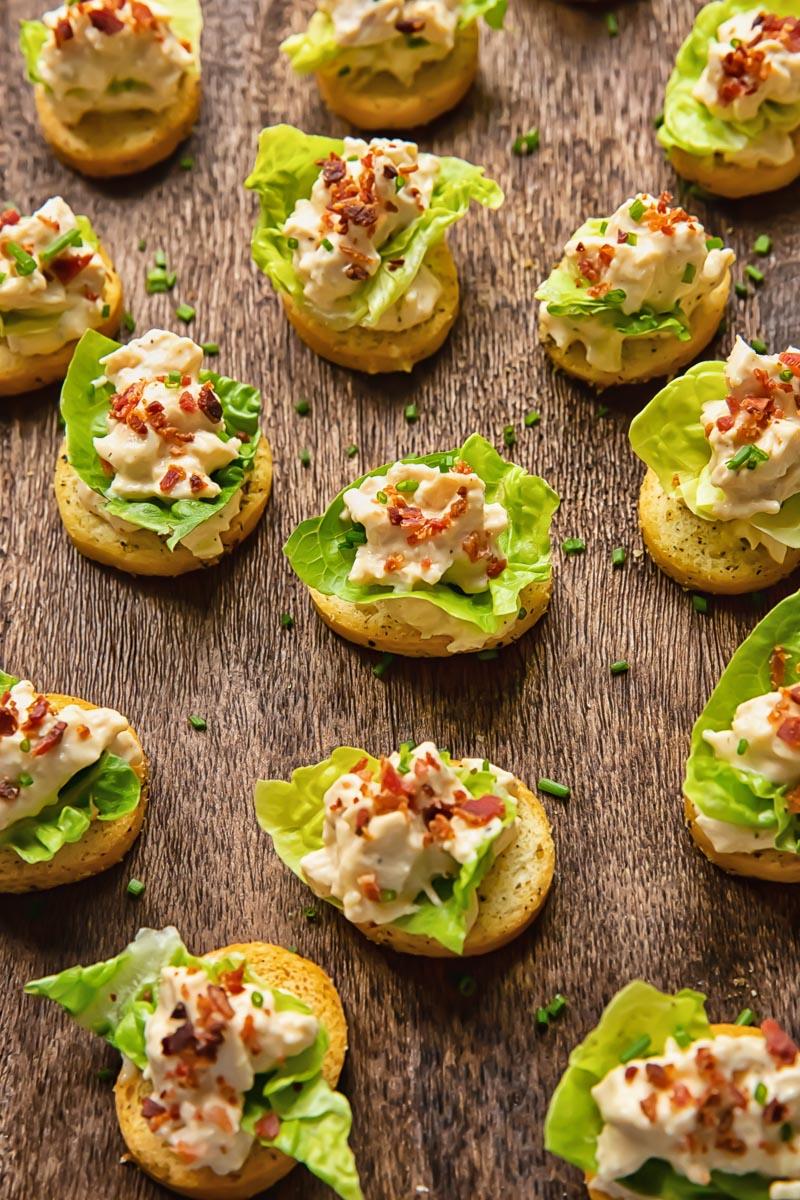 Close-up of a beautifully plated Chicken Caesar Salad with Crostini, highlighting the textures and colors.