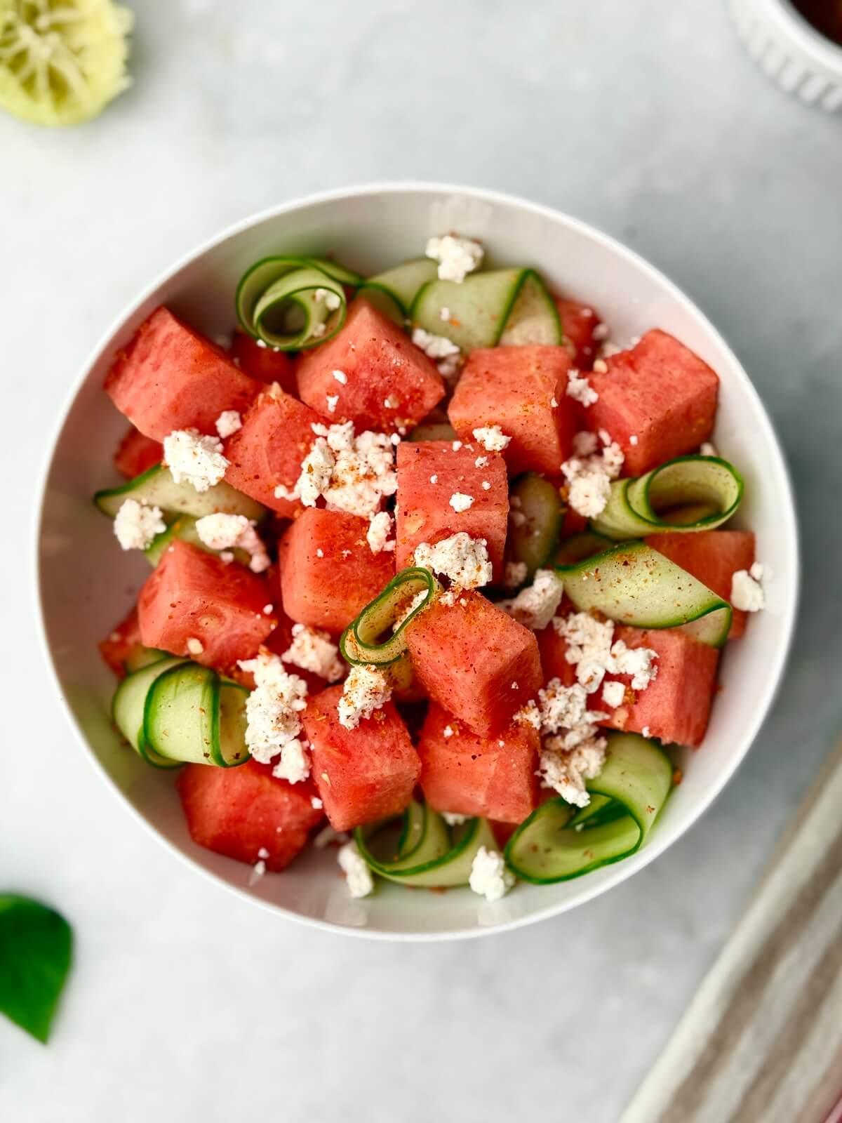Close-up of watermelon and cucumber ribbons with feta and mint