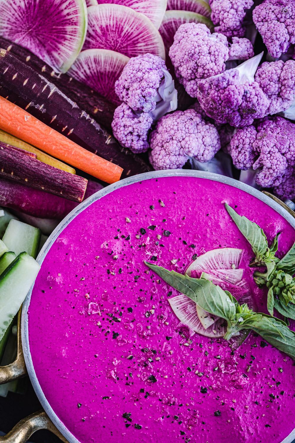 Close-up shot of creamy goat cheese dip with roasted beets and fresh herbs