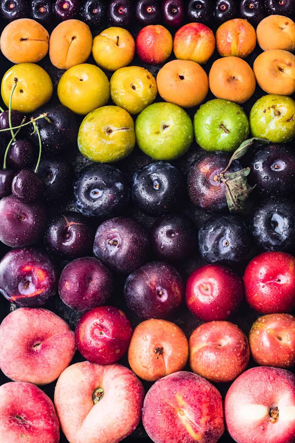 A close-up shot of various stone fruits on a platter, highlighting their vibrant colors and textures
