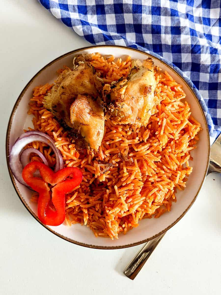 overhead shot of spiced jollof rice with vegetables and meat