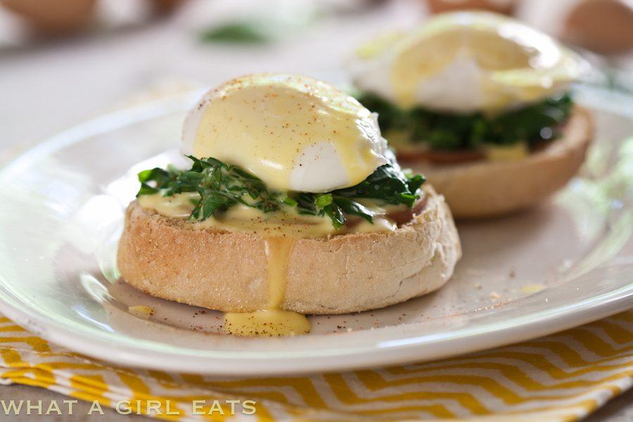 Close-up of the creamy hollandaise sauce drizzled over the eggs Florentine
