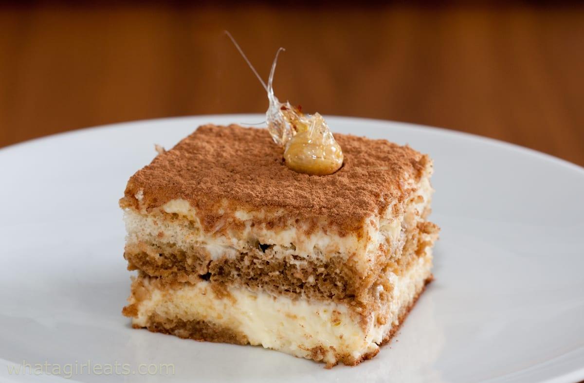 Close-up shot of a single serving of tiramisu, highlighting the layers and texture