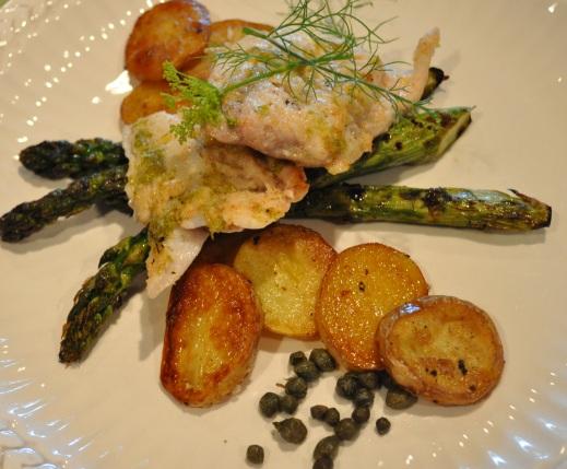 Grilled fish fillets with asparagus and potatoes on a grill