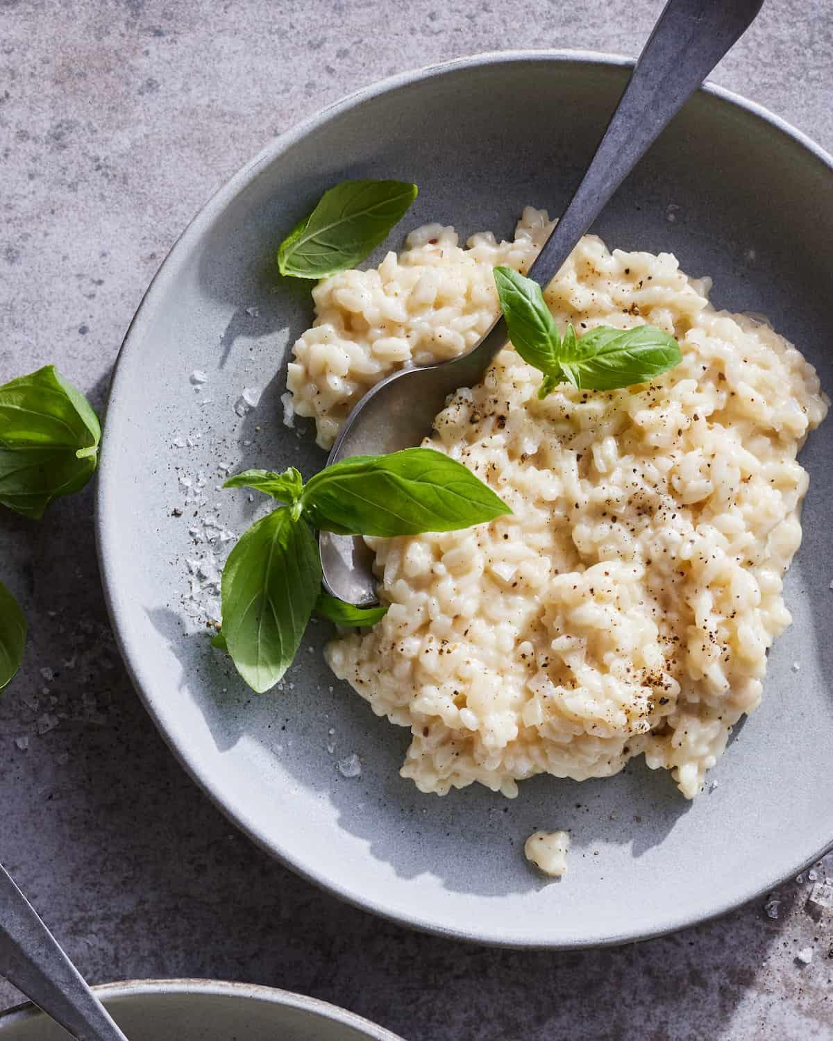 Overhead shot of creamy goat cheese risotto being served.