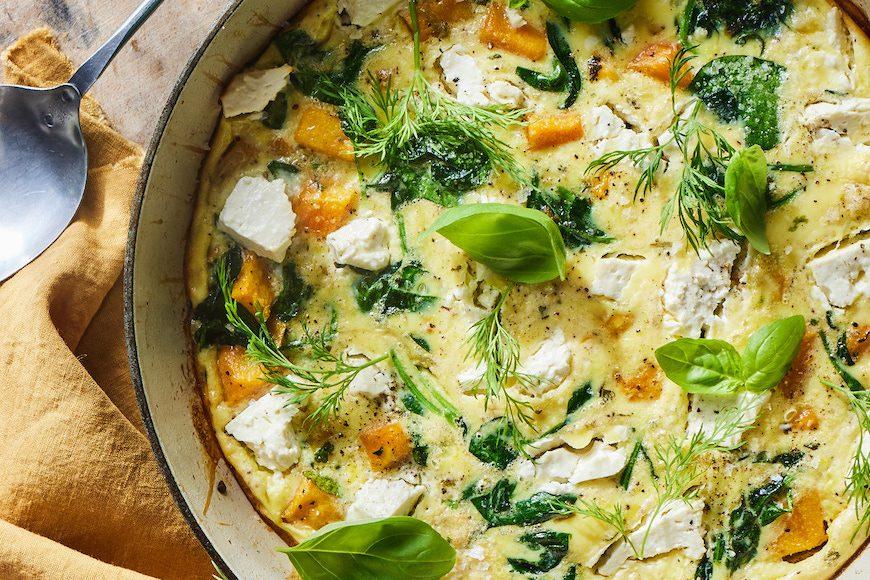 Close-up shot of a slice of Squash and Spinach Frittata with Feta, showing the texture and ingredients