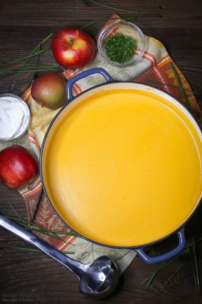 Close-up shot of a steaming bowl of butternut squash and apple soup