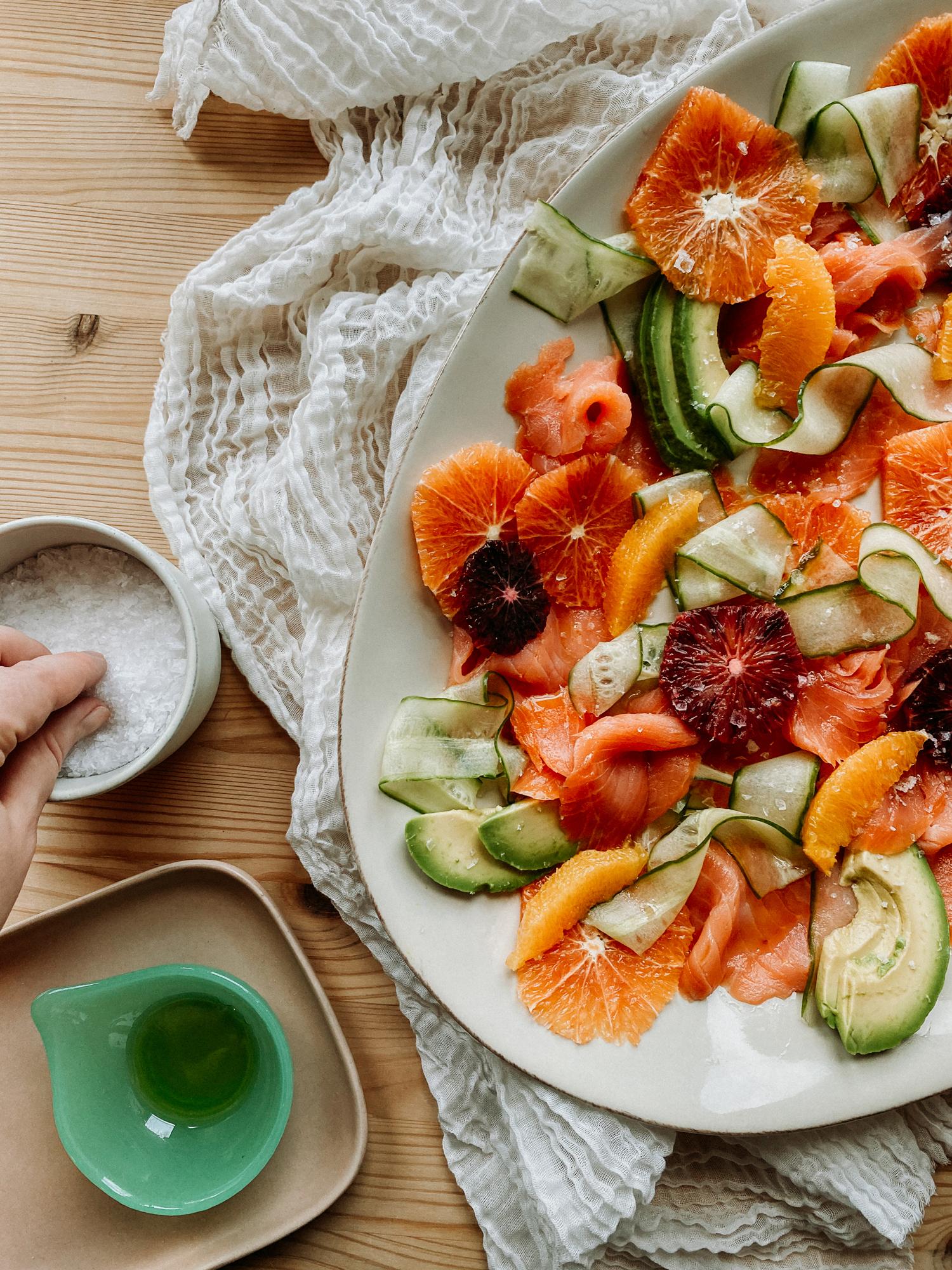 Smoked Salmon and Grapefruit Salad served on a rustic wooden platter