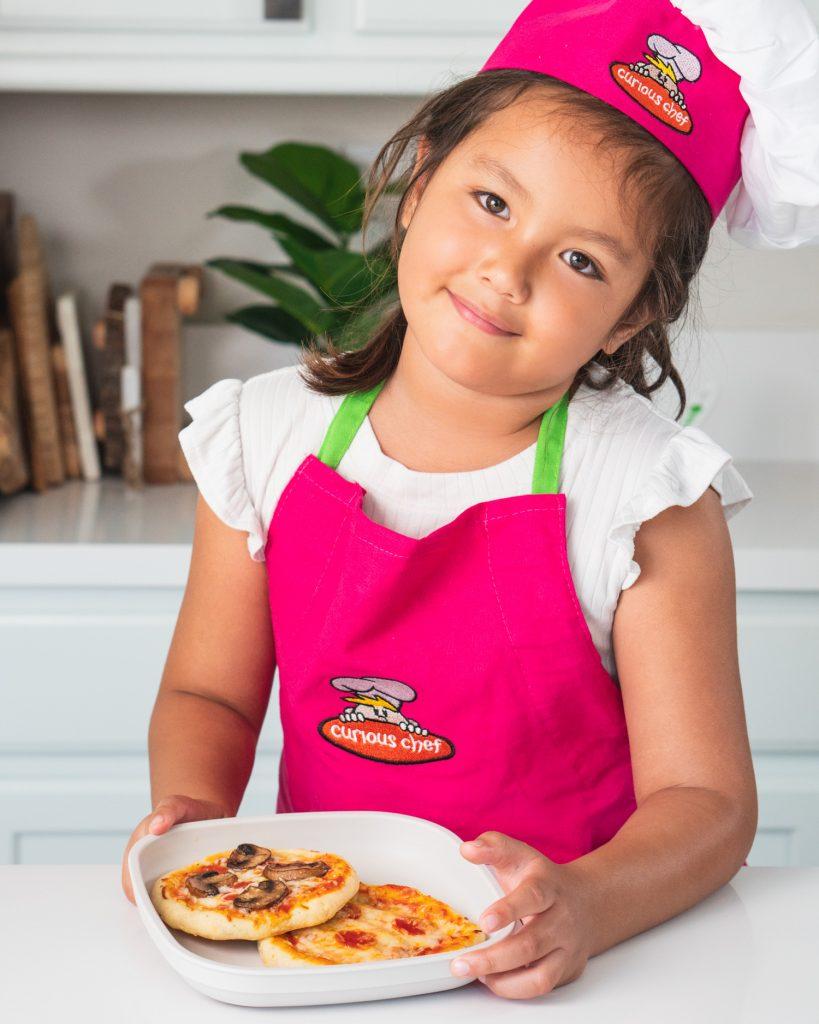 Children helping to make mini pizzas