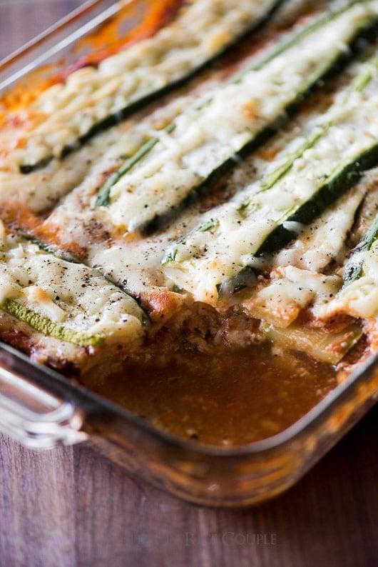 Close-up of layers of zucchini lasagna visible through the glass dish