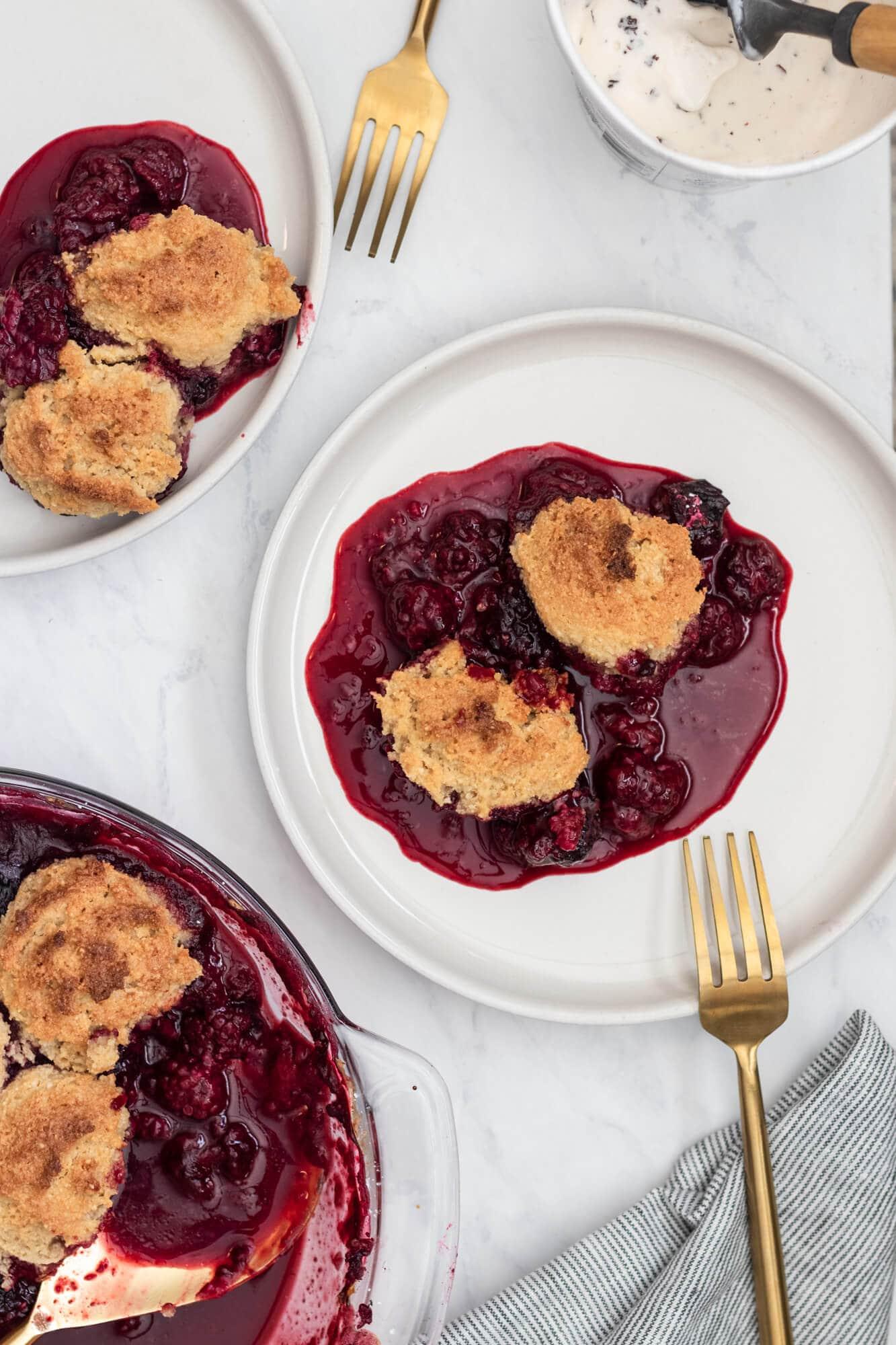 person taking a paleo mixed berry bar from a plate with a fork