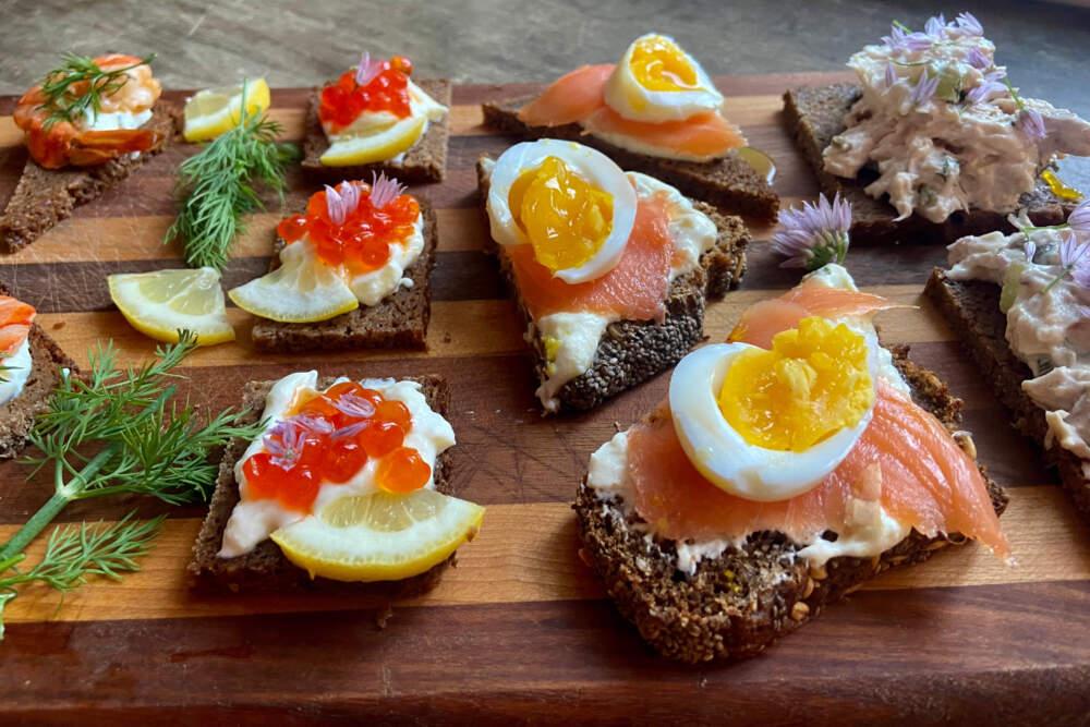 Close-up shot of elegant Orange & Chocolate Smørrebrød on a dark wooden board