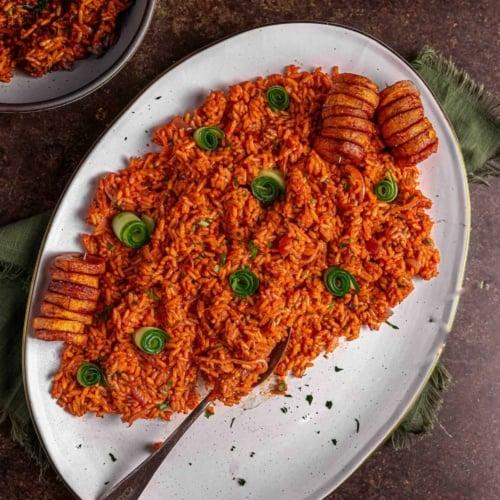 Close-up shot of a jollof pierogi being cut in half, revealing the flavorful jollof rice filling