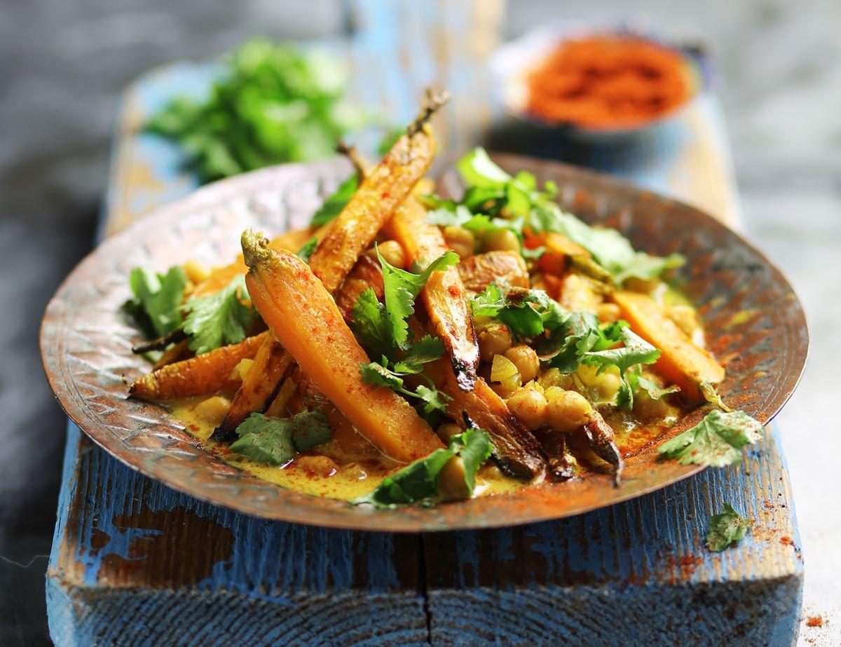 spiced carrot and chickpea tagine served with yogurt sauce and couscous