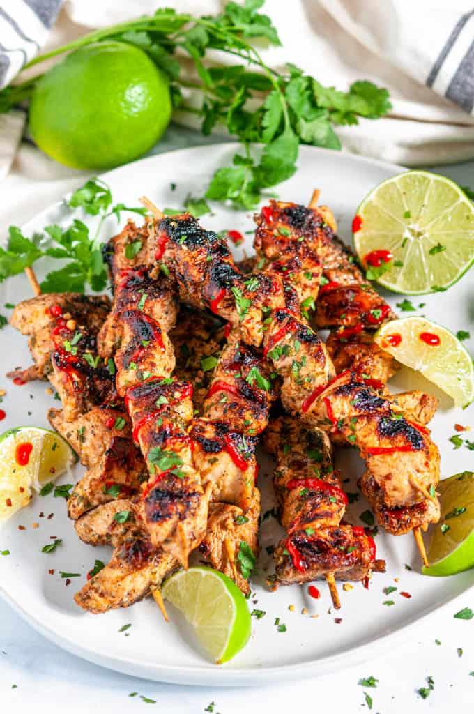 Close-up shot of delicious Sauerkraut-Lime Chicken Skewers on a grill, glistening with marinade