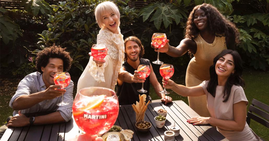 A group of friends enjoying Spicy Mango Martinis at a party