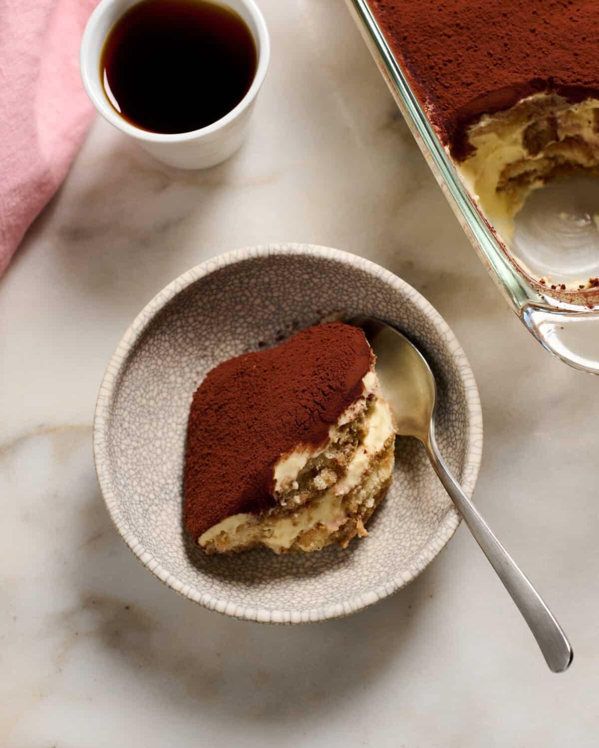 Close-up shot of a single Tiramisu Deviled Egg, highlighting the creamy coffee filling and cocoa dusting.
