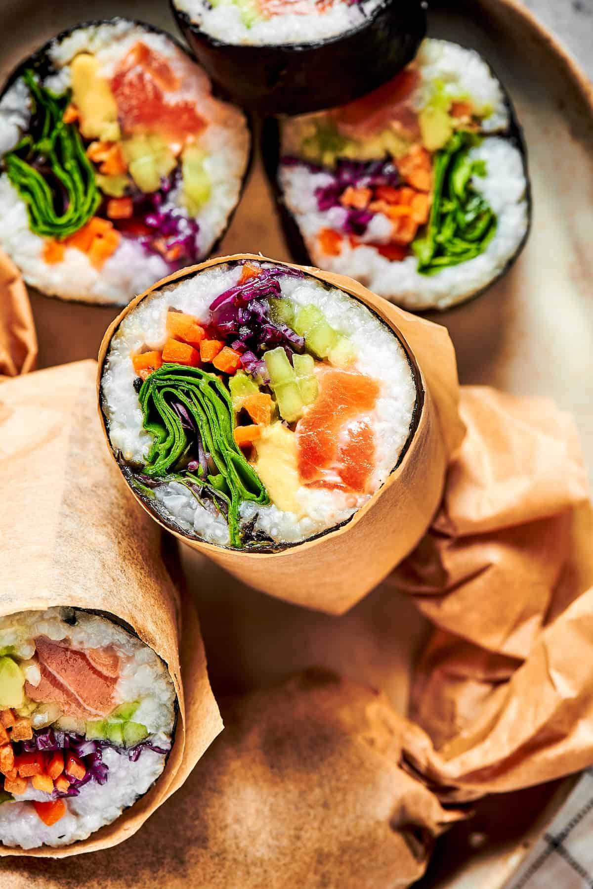 spicy salmon sunrise burrito cut in half, showcasing the filling