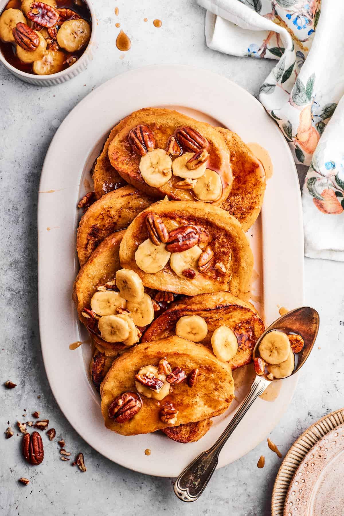 A person enjoying a slice of Banana Foster French Toast