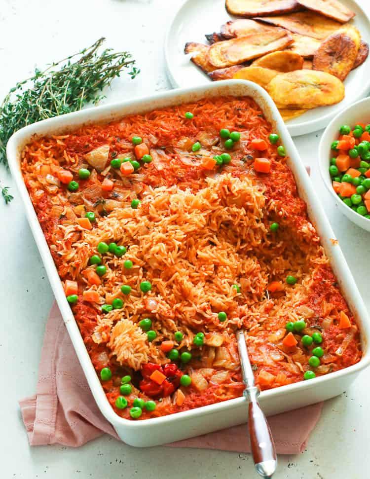 A vibrant and colorful bowl of Jollof Rice Breakfast Bowl with garnishes