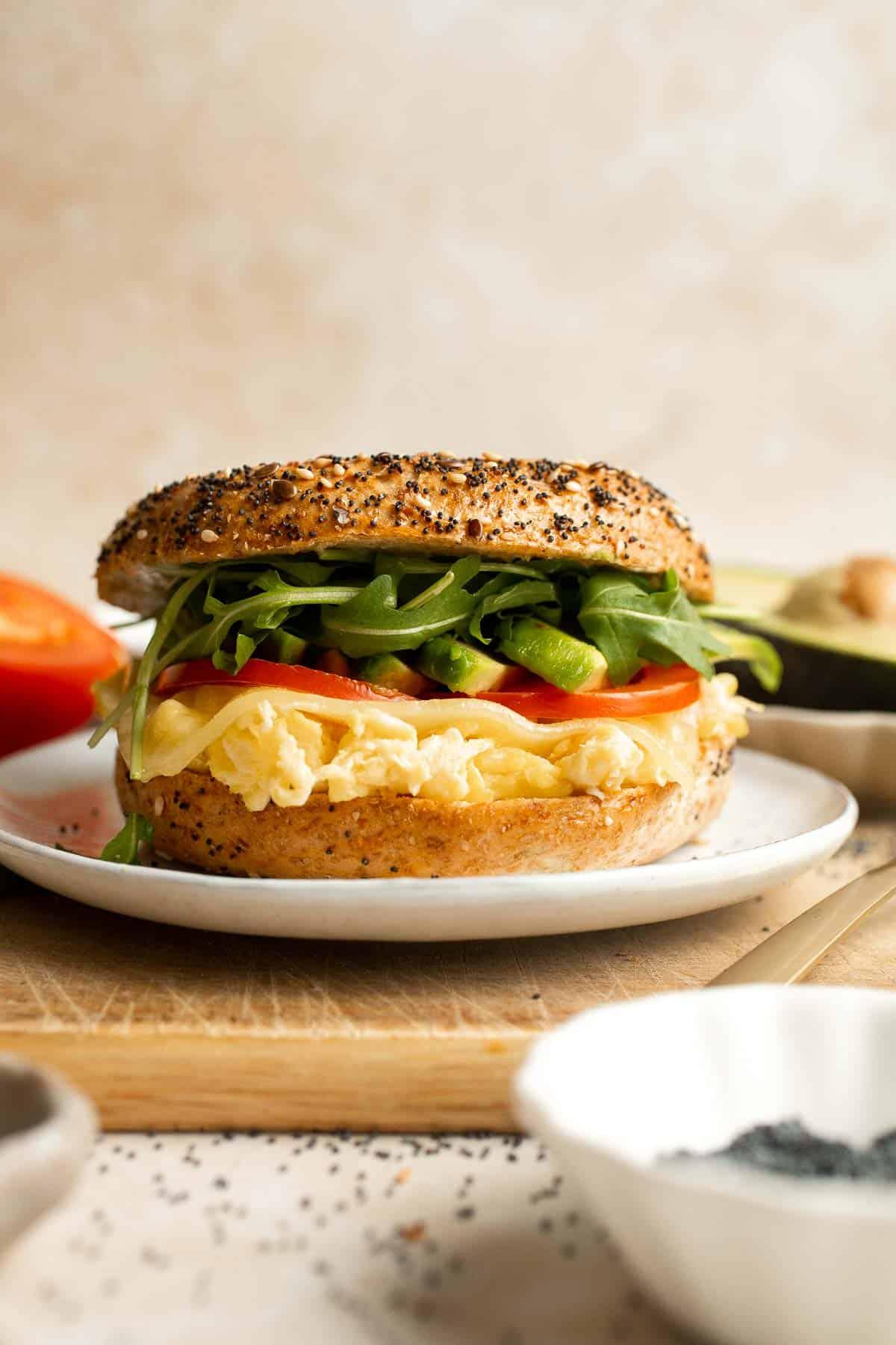 Close-up of a bagel with egg salad, lettuce and some finely chopped tomatoes