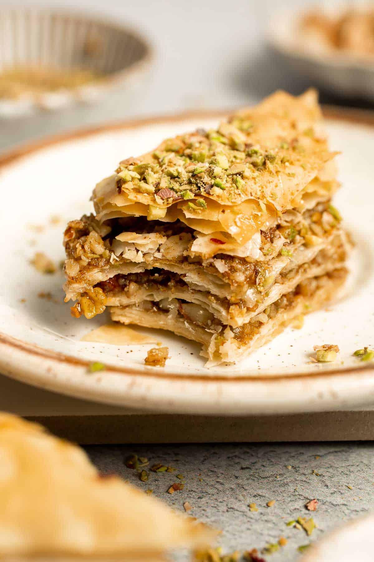 Close-up shot of a piece of Persian Baklava with Crystallized Ginger, showing the layers and glistening syrup