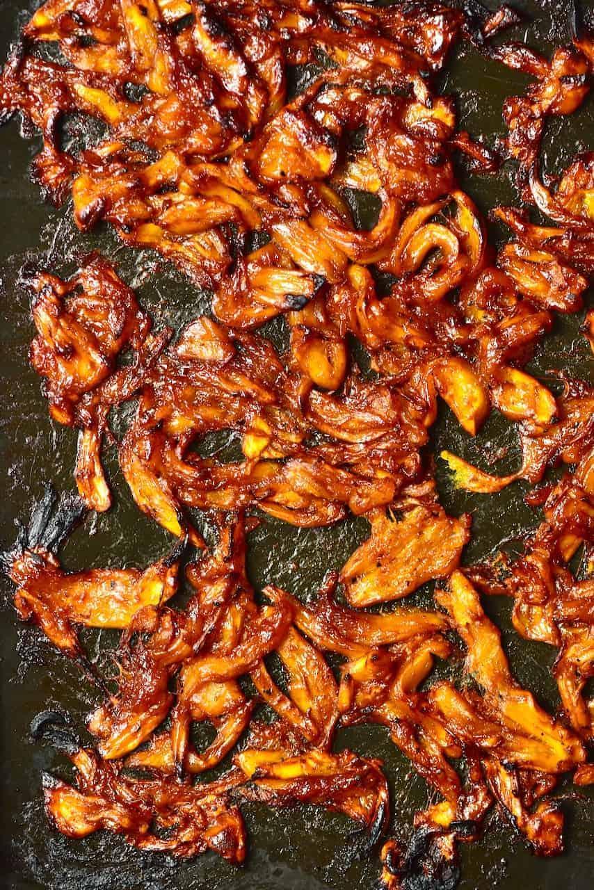 close-up shot of grilled jackfruit being basted with bbq sauce