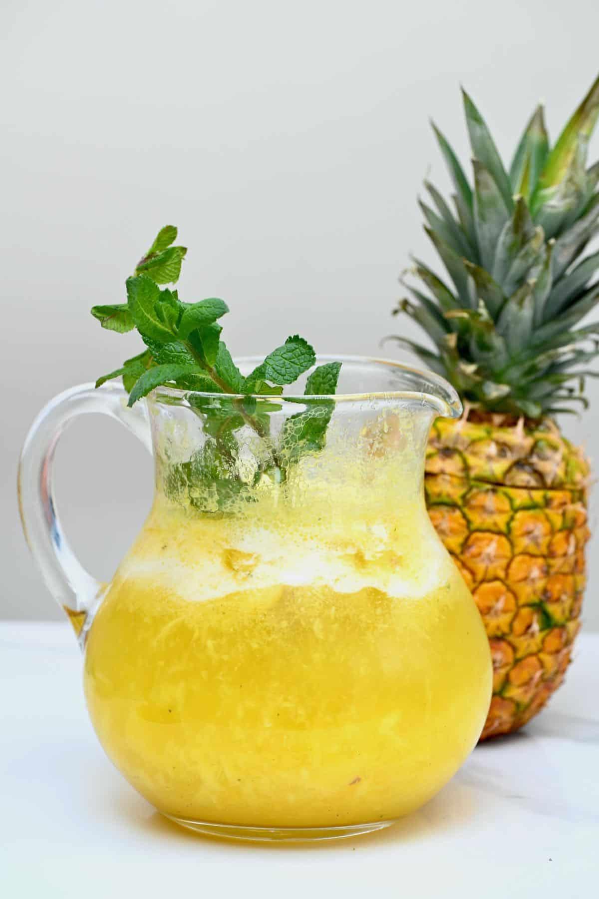 Various garnishes for Pineapple Ginger Zing Lemonade: pineapple, mint, ginger