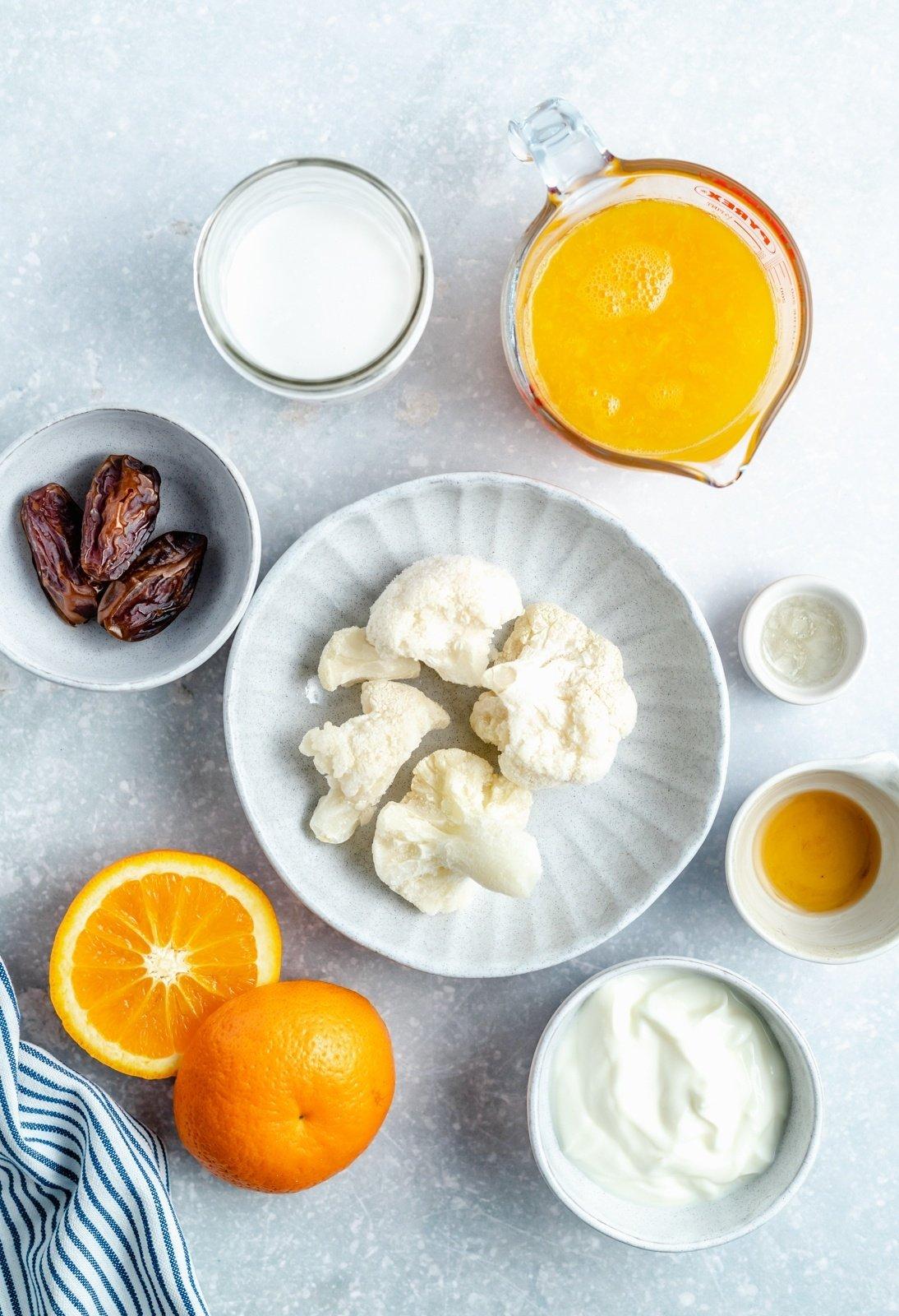 Orange creamsicle smoothie ingredients arranged on a table