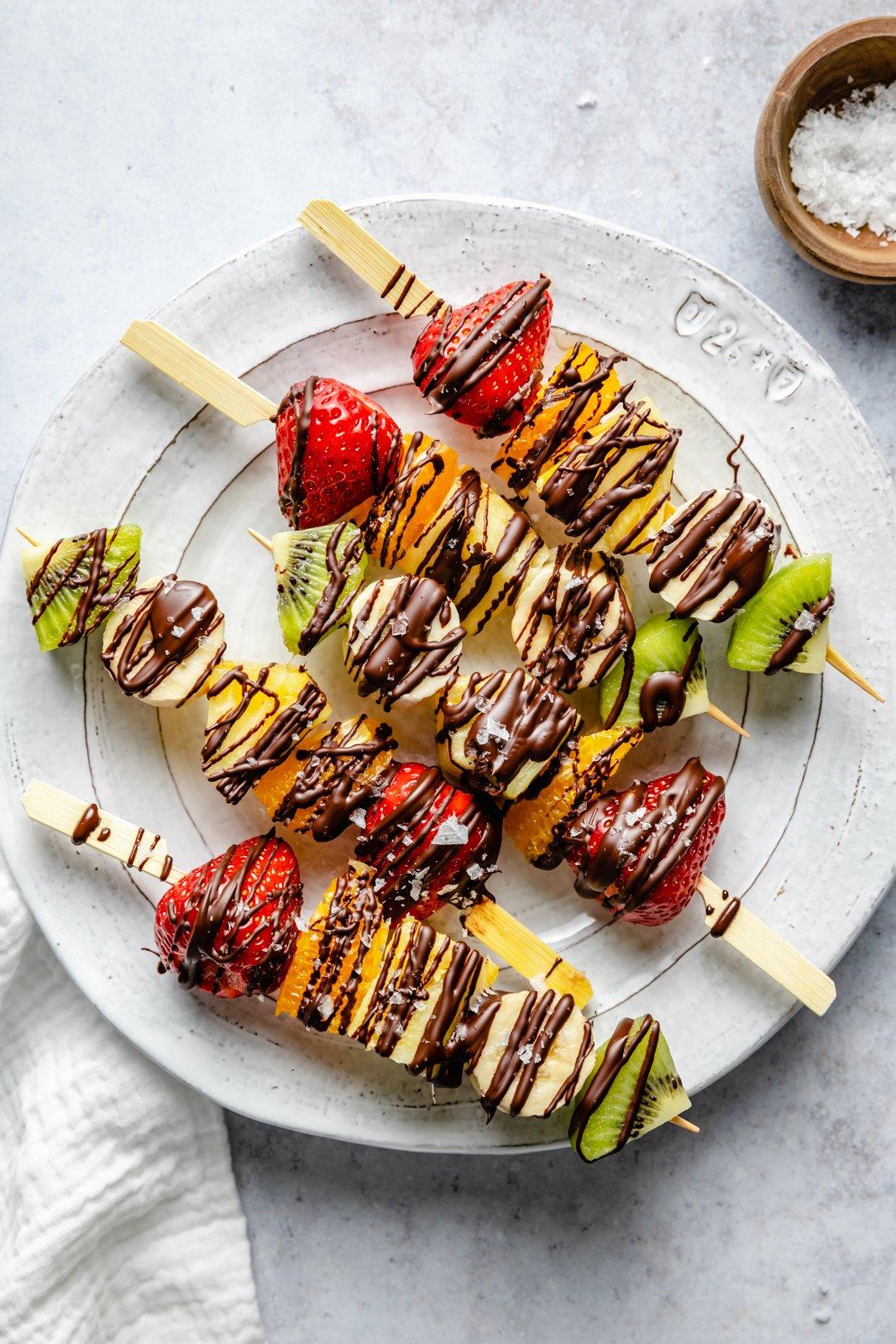 Colorful fruit kabobs drizzled with coconut water