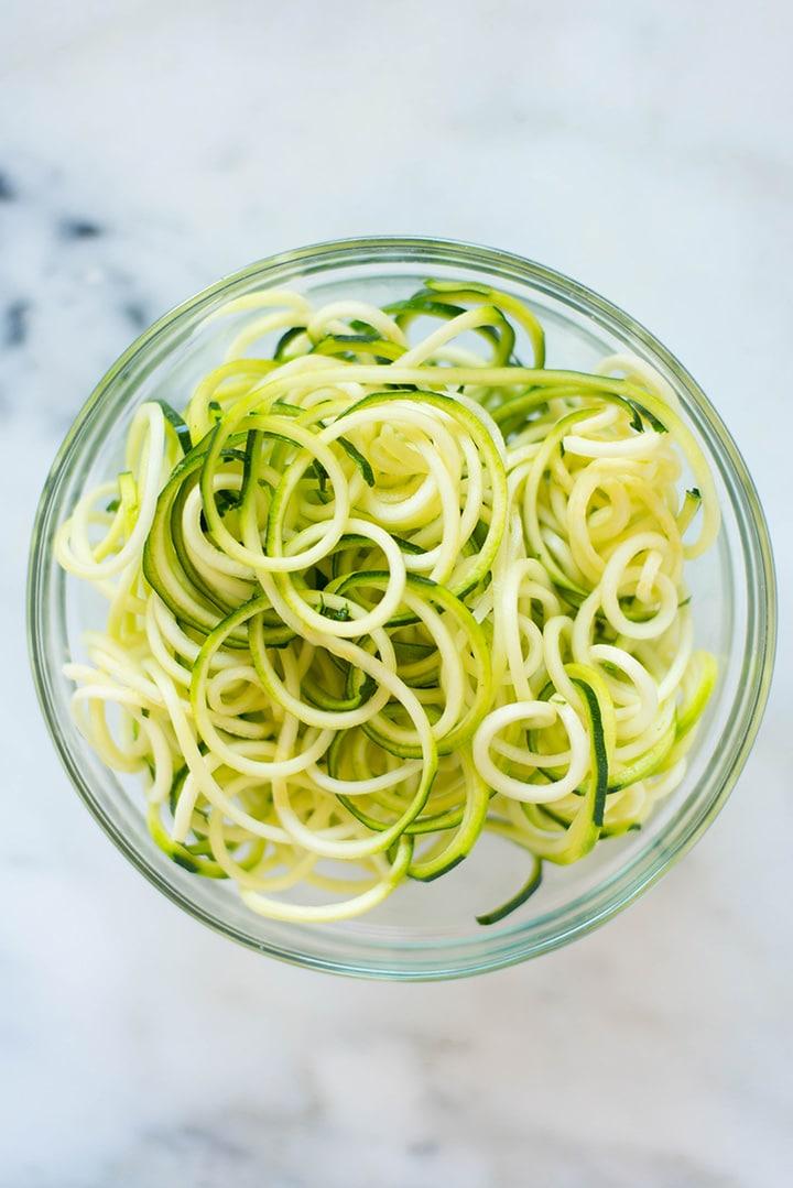 overhead view of zoodles being spiralized with a spiralizer