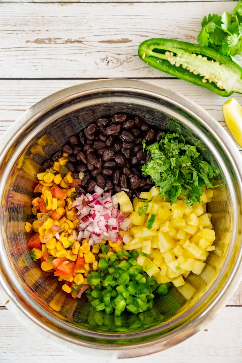 Close up shot of black bean mango pineapple salsa in a bowl
