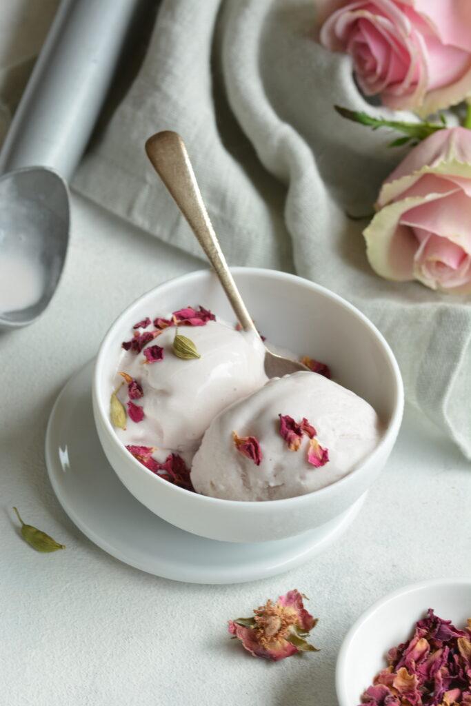 A bowl of cardamom ice cream with rose petals