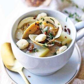 bowl of injera clam chowder with fresh herbs