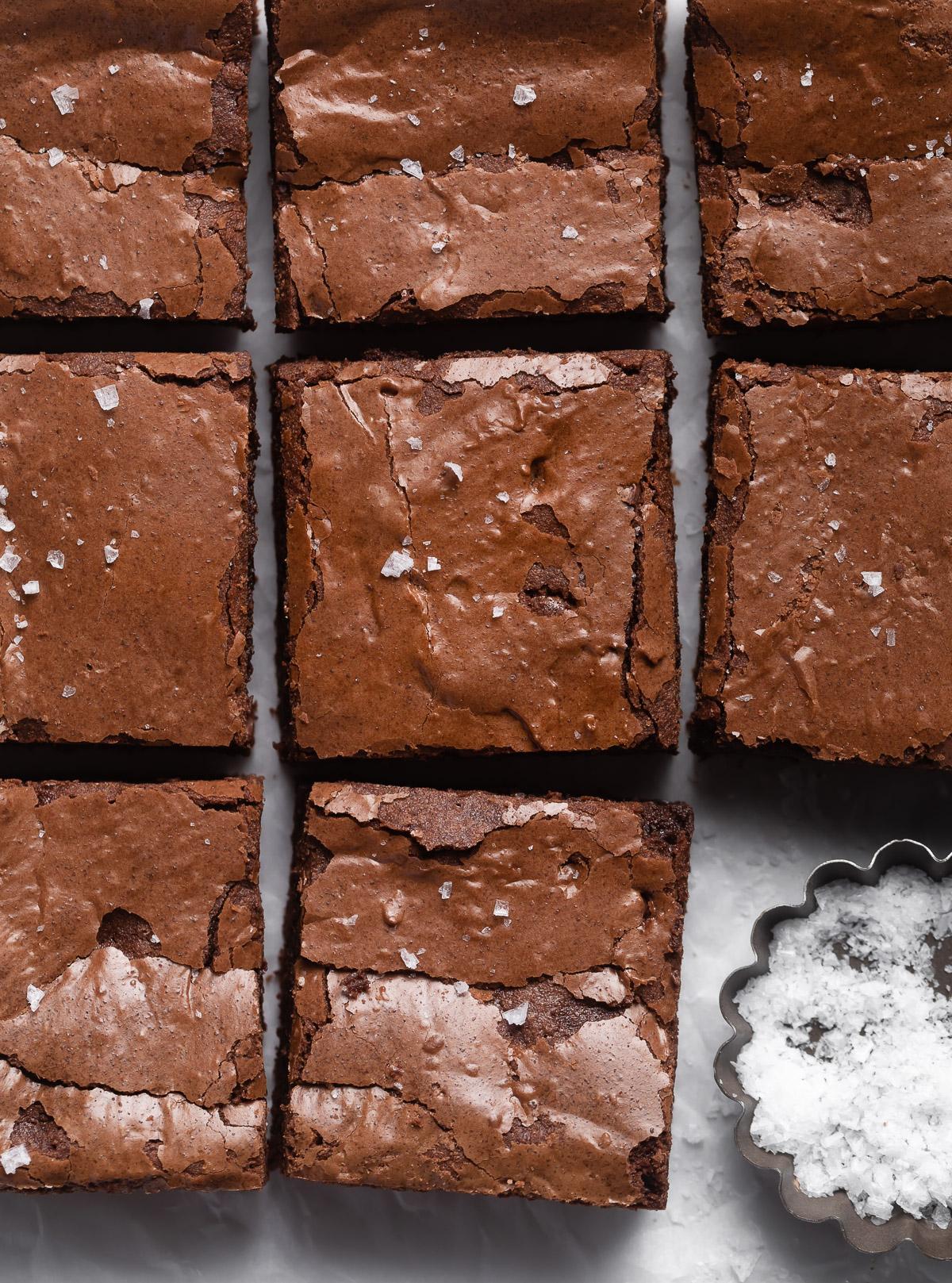 A person cutting a square of brownie brown butter blondies