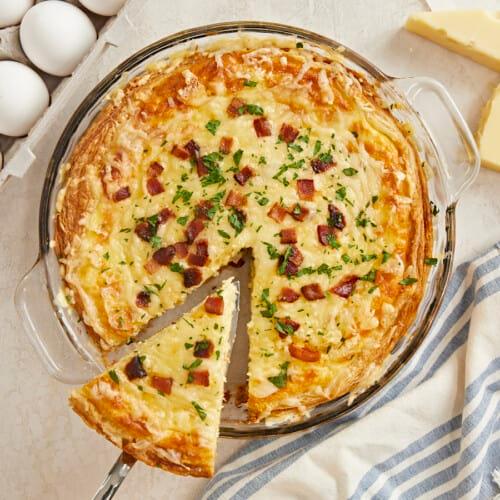 overhead shot of the quiche with a slice being taken out