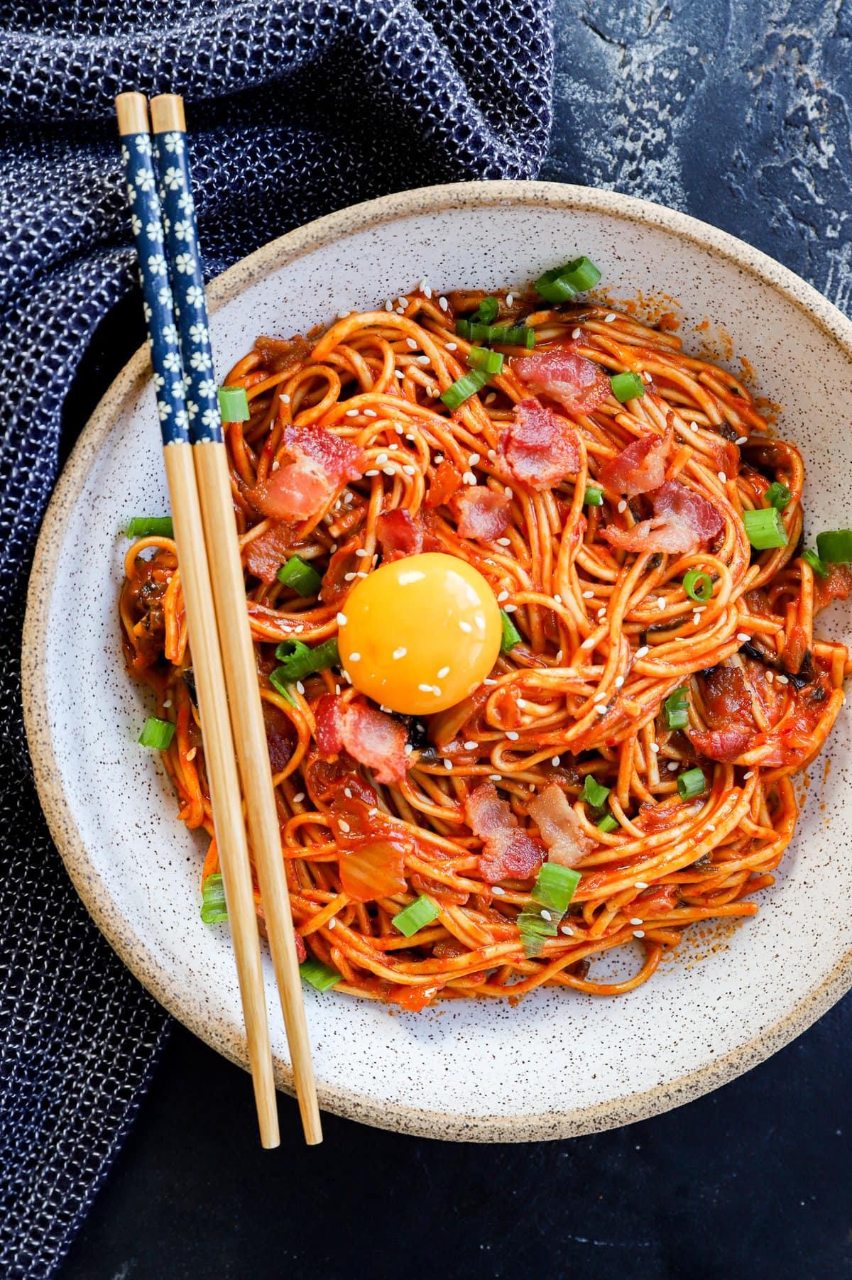Kimchi Udon with Seafood in a large bowl, garnished with green onions