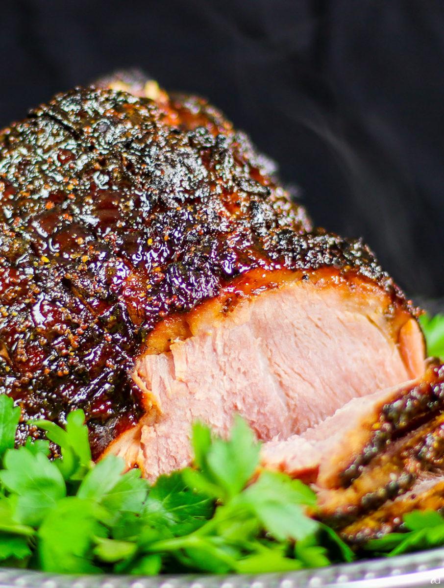 A close-up shot of the mustard crust on the ham, highlighting its texture and color